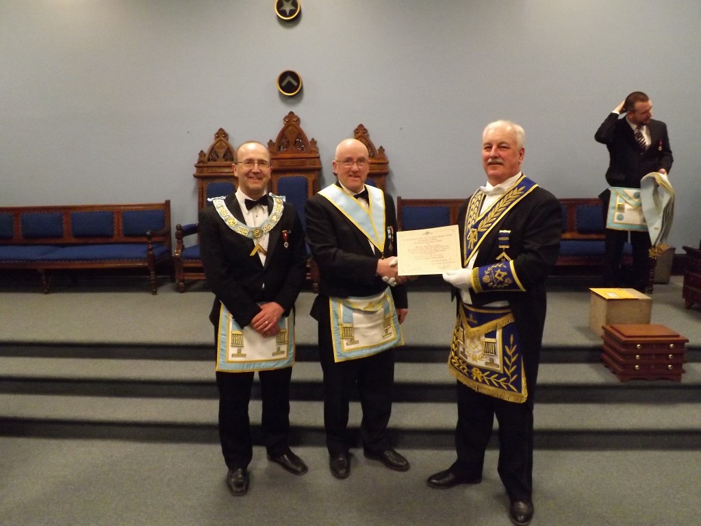 W. Bro. Wayne Fiset (WM) W. Bro Harry Lewis (PM )receiving his Past Masters Certificate R. W. Bro. Brian Olson (DDGM 2013-2014)
