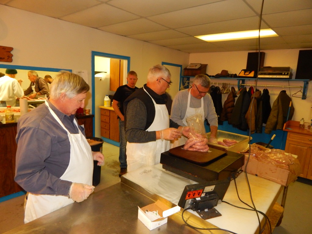 At the last sausage-making in Wawa on November 28th, 2015 V.W. Bro. Steve Turyk (centre) and W. Bro. Scott Robinson package up 5lbs under the watchful eye of Bro. Bill Chapman
