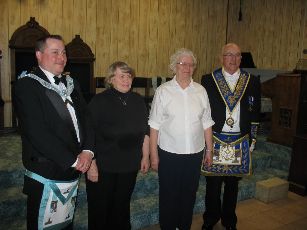 Two Ladies receive Widows Pins from the W. Master of Elliot Lake Lodge W. Bro. Andrew Todd and the DDGM of Algoma East District R.W. Bro. J. Henry Lewis